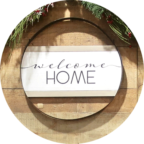 Black and white round welcome home sign.
